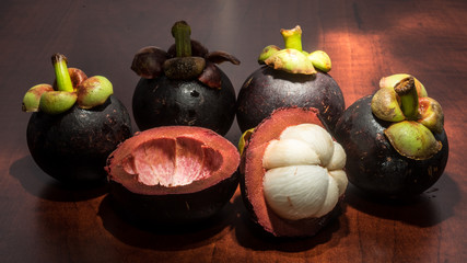 Tropical fruits mangosteen on the wooden table