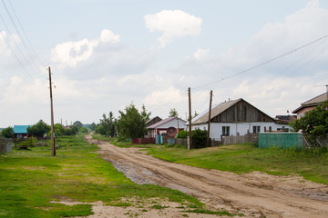Fototapeta na wymiar street in the Russian village with a dirt road