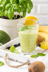 Green smoothie with banana, kiwi, Basil and avocado. Delicious healthy drink, summer snack, fresh taste