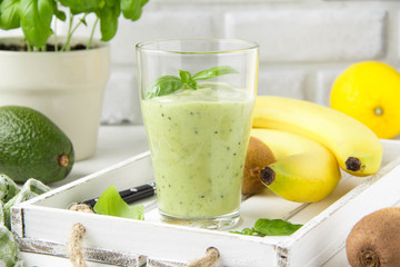 Green smoothie with banana, kiwi, Basil and avocado. Delicious healthy drink, summer snack, fresh taste