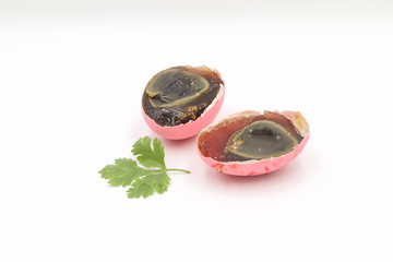 Century pink eggs with coriander leaves on a white background