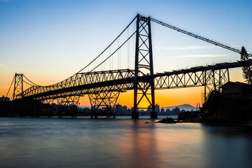 landscape with cable-stayed iron bridge at sunset with seascape with blue and golden sky, Hercilio Luz Bridge Florianopolis - Santa Catarina - Brazil