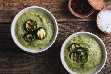 Healthy zucchini cream soup in ceramic bowls