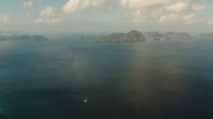 Cove with tropical rocky islands covered with rainforest, sea with blue water, aerial view. El nido, Philippines, Palawan. Tropical Mountain Range