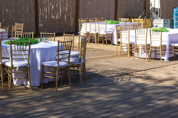 patio restaurant exterior environment with tables and chairs empty wooden furniture 