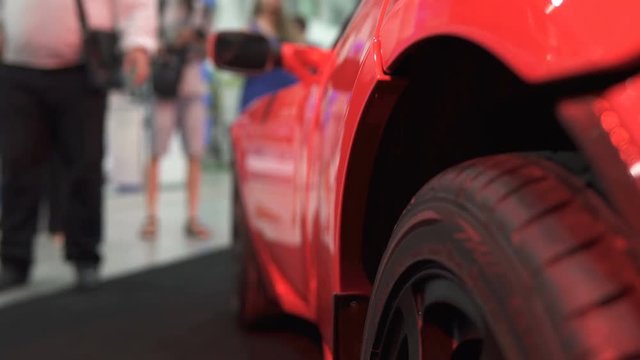 A person chooses and buys an electric car at the exhibition
