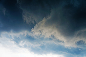 Fototapeta premium Gloomy scary rain clouds in the blue sky.