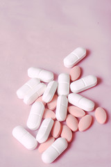 many pills on the pink background