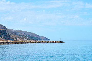 Seaside and harbor in Colimbari, Crete, Greece with blue sky and sea. Copy space. 