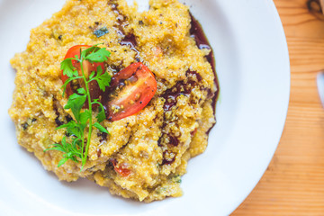 Close up of a fresh polenta with tomatoes. Vegetarian meal.