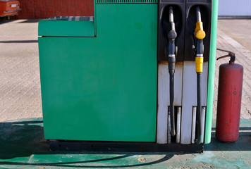 Old gasoline station and red fire extinguisher.