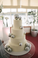 Big white wedding cake with fruit is on the table