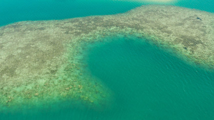 Sea water surface in lagoon and coral reef, copy space for text, aerial view Top view transparent turquoise ocean water surface. background texture