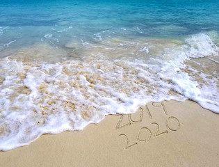frothy ocean surf and sand for New Year 2020 holiday