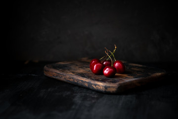 Cherries on a wooden Board, still life with berries in rustic style