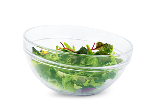 Fresh salad in a glass plate on a white background
