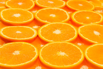 Slices of oranges as a background, top view.