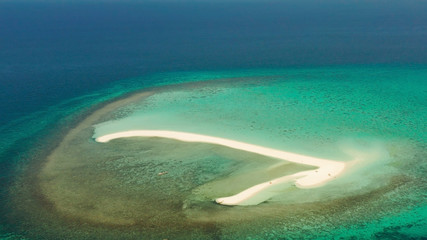 Fototapeta premium Sandy white island with beach and sandy bar in the turquoise atoll water, aerial drone. Sandbar Atoll. Tropical island and coral reef. Summer and travel vacation concept, Camiguin, Philippines.