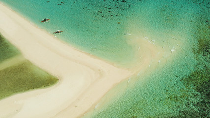 Sandy white island with beach and sandy bar in the turquoise atoll water, aerial drone. Sandbar Atoll. Tropical island and coral reef. Summer and travel vacation concept, Camiguin, Philippines.