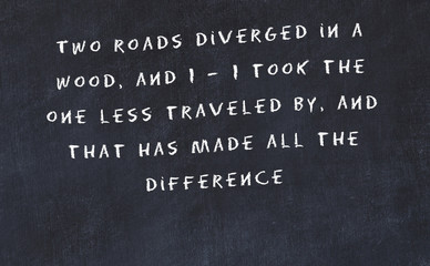 Black chalkboard with handwritten wise motivational quote 