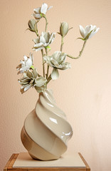 Artificial magnolia blossoms in a vase