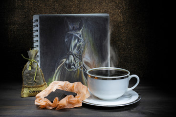 Composition cup of coffee, coffee beans, horse drawing and chocolate.