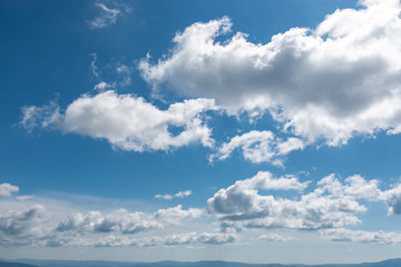 white clouds in bright blue sky