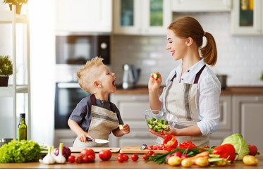 happy family mother with child son preparing vegetable salad .