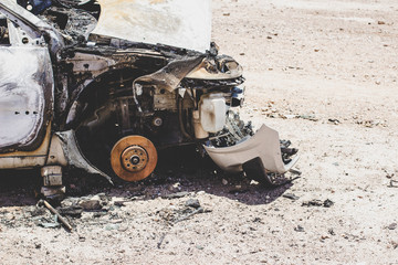 Fototapeta premium broken car remains after fire on a wasteland dump environment 