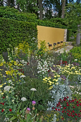 An interesting large scale garden with architectural features and a colourful flower border