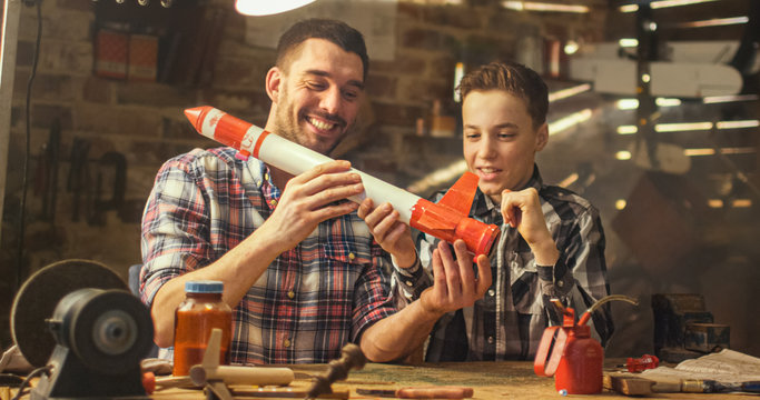 Father and son are modeling a toy rocket in a garage at home.