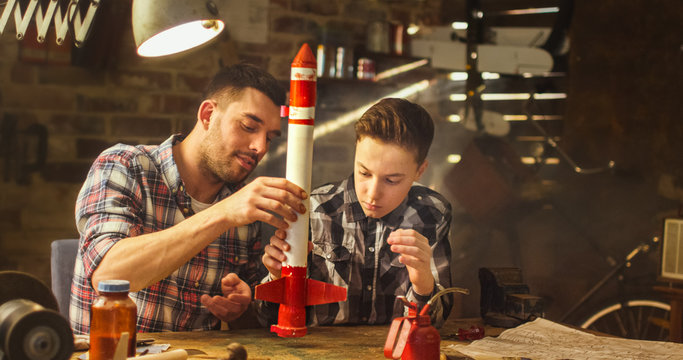 Father and son are modeling a toy rocket in a garage at home.