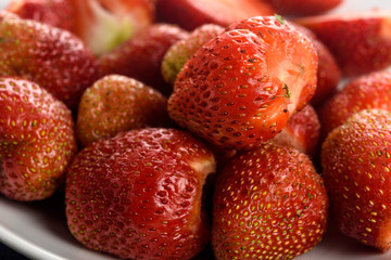 peeled berries of garden strawberry on a plate close-up