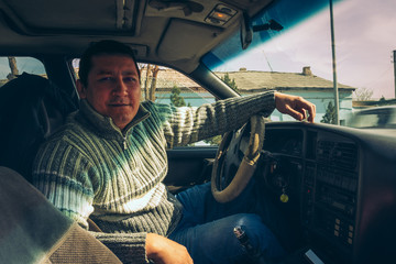 a local driver in an old car - obrazy, fototapety, plakaty