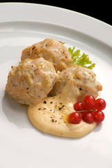 Diet steam meatballs with sauce and red currant close-up on a plate.