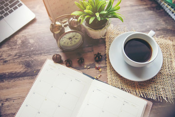 Planner and Concept.Desktop Calender 2022, laptop, cup of coffee place on office desk,working...