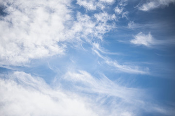 white cirrus clouds against the blue sky. fluffy clouds