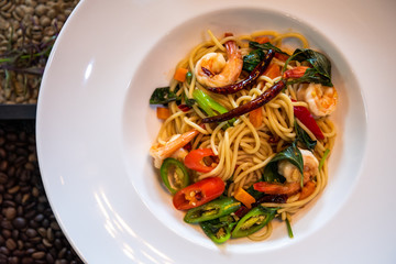 Spaghetti with spicy prawn in white dish closed up