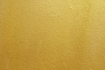 Gold concrete wall on background texture.