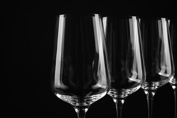 Set of empty wine glasses on black background
