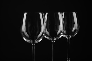 Set of empty wine glasses on black background