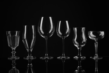 Set of empty glasses on black background
