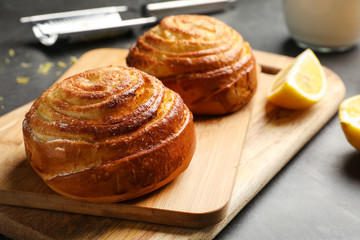 Wooden boards with tasty buns on table, closeup. Fresh from oven