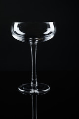 New empty champagne glass on black background