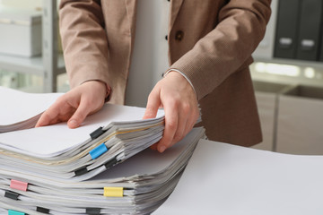 Woman working with documents in office, closeup