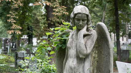 Fototapeta na wymiar Guardian Angel Sculpture In A Graveyard