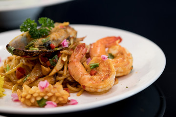 Seafood spaghetti in a white ceramic dish
