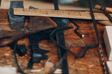 Tool carpenter on the table. Planer, ruler, hammer, drill, saw.