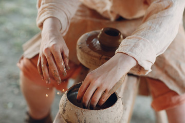 Potter makes a pot of clay