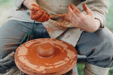 Potter makes a pot of clay
